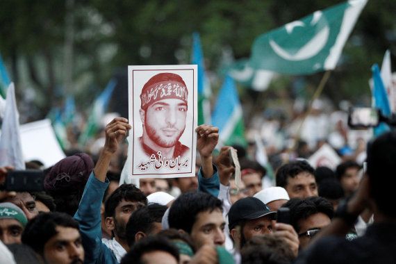 A picture of Hizbul Mujahideen commander Burhan Wani is held up during a rally condemning the violence in Kashmir, in Islamabad, Pakistan, on July 24, 2016. REUTERS/Caren Firouz