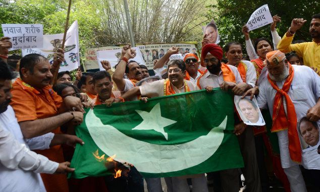 Indian activists of Shiv Sena shout anti-Pakistan slogans and burn poster of Pakistani Prime Minister Nawaz Sharif during a protest in New Delhi.(Photo by India Today Group/Getty Images/India Today Group/Getty Images)