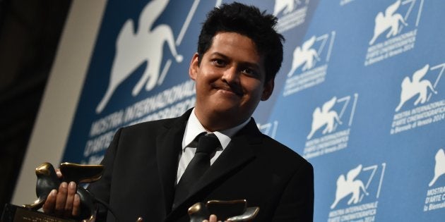 Writer and director Chaitanya Tamhane poses with the Orizzonti Award for Best Film and the Lion of the Future for a debut film (Luigi De Laurentis) for his movie 'Court' during a photocall following the awards ceremony on the closing day of the 71st Venice Film Festival on September 6, 2014 at Venice Lido. AFP PHOTO / GABRIEL BOUYS (Photo credit should read GABRIEL BOUYS/AFP/Getty Images)