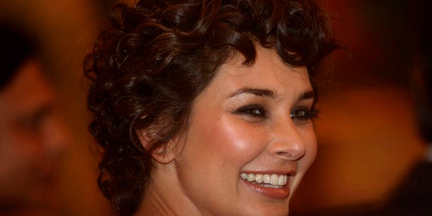 Bollywood actress and model Lisa Ray smiles during the launch of LifeCell Femme Menstrual blood banking service in Mumbai, India, Tuesday, March 8, 2011. LifeCell is the first and only company offering menstrual blood banking to harvest stem cells in India. (AP Photo/Rafiq Maqbool)