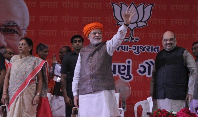 Prime Minister Narendra Modi waves during a reception accorded to him by Bharatiya Janata Party supporters upon his first visit to his home state after assuming office in Adalaj near Ahmadabad, Sept. 16, 2014.