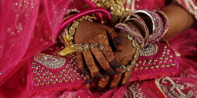 A Muslim bride waits for the start of a mass marriage ceremony in Mumbai, India, January 27, 2016.