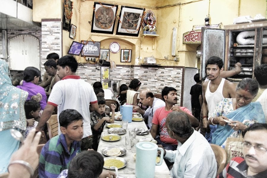 People wolfing down kachoris inside Sri Hari Mishtanna Bhandar.