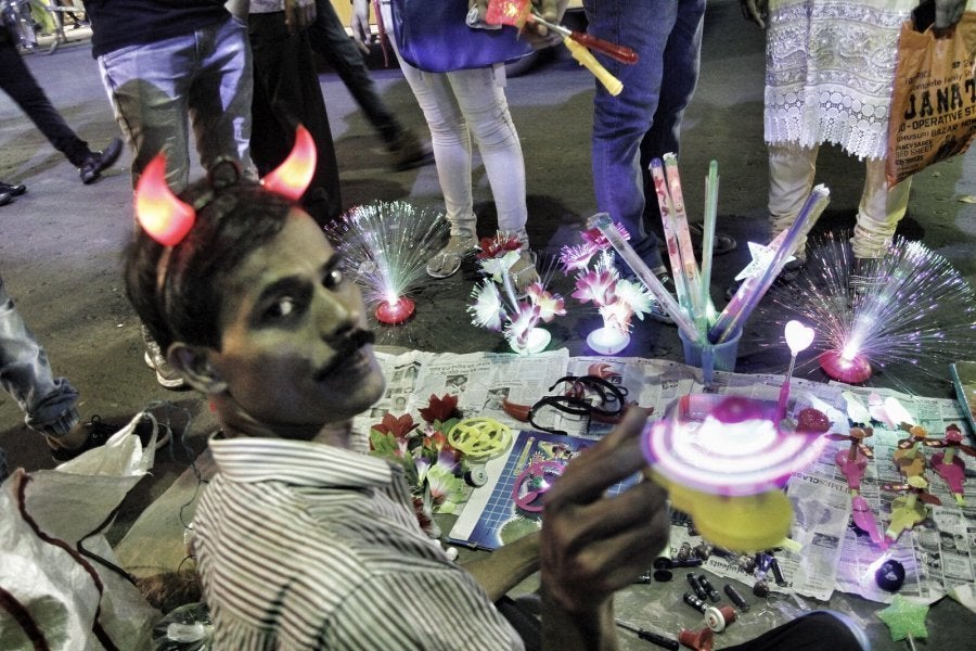 Bimal Das has no time this year to take his family out for pandal hopping. He lives in Barasat and comes daily to Kolkata to work. He says that during the Puja's he makes some extra money by selling odds and ends.