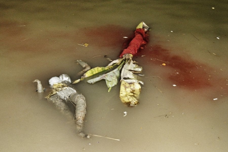 As the water swallows the earthen parts of the idols, the wood and hay framework floats in the river. These are then salvaged by locals and sold off, to be made into new idols next year.