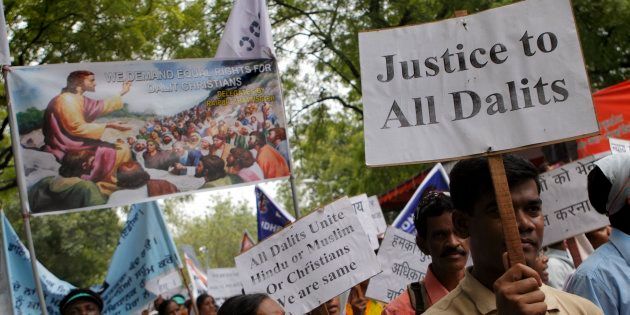 Dalit Christians, or India's lowest-caste "untouchables" who converted to Christianity, hold placards as they march to the Indian parliament in New Delhi, India.