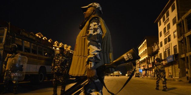 Indian paramilitary troopers patrol during a curfew in Lal Chowk in Srinagar on August 14, 2016