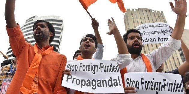 Activists from ABVP shout slogans during a protest against Amnesty International in New Delhi.