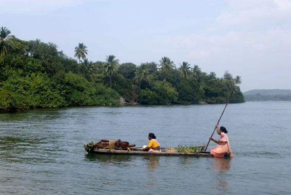 Village women rowing boat in Karli River