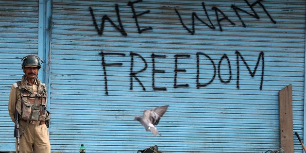 Graffiti is painted on shop shutters in Srinagar after an escalation of violence that officials have blamed on separatist protests that have tied down security forces for more than a month in Kashmir.