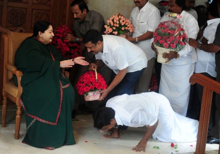 A party cadre prostrates himself at the feet of All India Anna Dravida Munnetra Kazhagam(AIADMK) leader Jayalalithaa Jayaram as she gestures at her residence in Chennai on May 19, 2016. The makeup of India's next government could lie in the hands of a trio of women who command a massive following in their regional heartlands, including a populist former movie star known as 'Mother' to supporters. / AFP / ARUN SANKAR (Photo credit should read ARUN SANKAR/AFP/Getty Images)