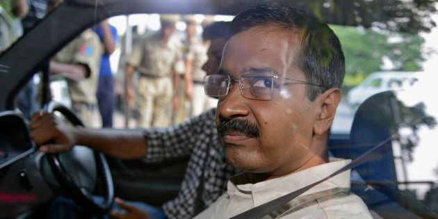 Arvind Kejriwal, the head of the Aam Aadmi Party (AAP), which briefly controlled the state government in Delhi, looks out from inside his car as he arrives at a court in New Delhi May 21, 2014.