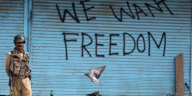 Graffiti is painted on shop shutters in Srinagar after an escalation of violence that officials have blamed on separatist protests that have tied down security forces for more than a month in Kashmir, August 17, 2016. REUTERS/Cathal McNaughton