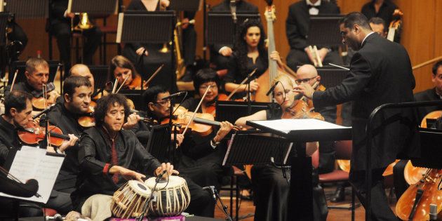Associate Music Director Zane Dalal leads the world premiere performance Zakir Hussain’s 'Peshkar', with Hussain as the soloist. 'Peshkar', a concerto for tabla and orchestra, was the first piece commissioned by the SOI.