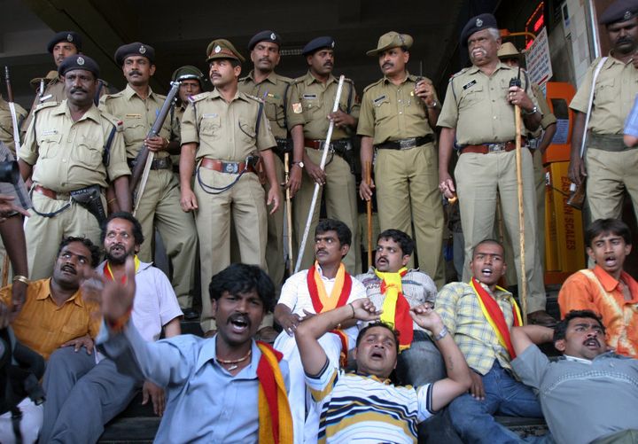 Pro Karnataka activists lie on the ground as they shout slogans to protest against the verdict of Cauvery water dispute.