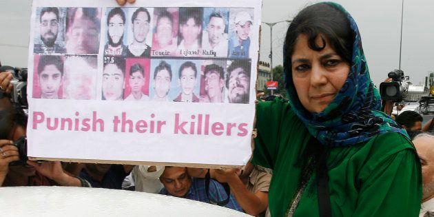 Mehbooba Mufti, chief of People's Democratic Party (PDP) Kashmir's main opposition party, shows pictures of killed youths during a protest in Srinagar July 29, 2010.