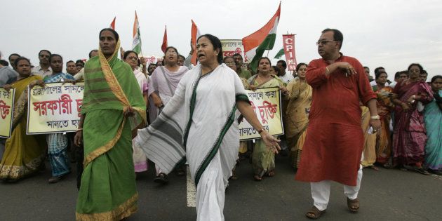 File photo of leader of India's Trinamool Congress (TMC) party Mamata Banerjee (C) marching beside the unfinished Tata Motors plant at Singur on September 26, 2008.