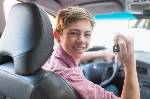 USA, New Jersey, Jersey City, Teenage boy (16-17) driving his first car