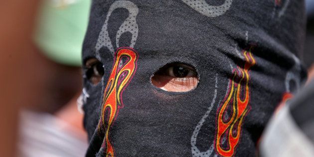 A masked protester attends a protest in Srinagar, against the recent killings in Kashmir September 18, 2016.