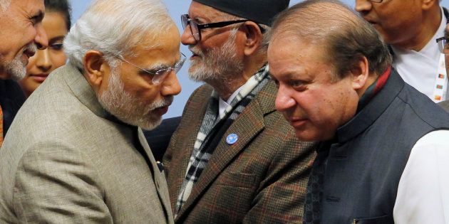 India's Prime Minister Narendra Modi (L) talks to his Pakistani counterpart Nawaz Sharif (R) during the closing session of 18th South Asian Association for Regional Cooperation (SAARC) summit in Kathmandu November 27, 2014.