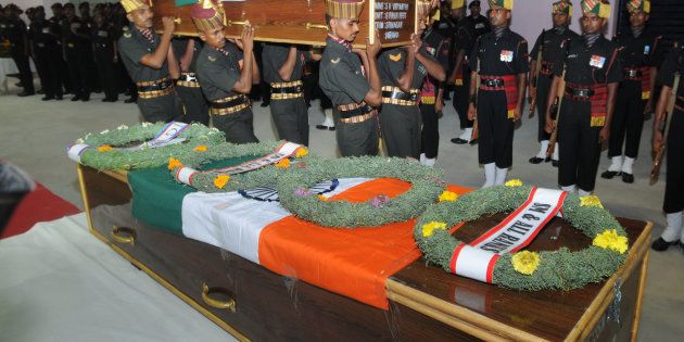 Army personnel arranging remains of Late Martyrs Naiman Kujur and Jawara Munda, Jharkhand, and SK Vidyarthi, Varanashi, for tribute, who were killed in Uri terror attack, at Birsa Munda Airport on September 19, 2016 in Ranchi.