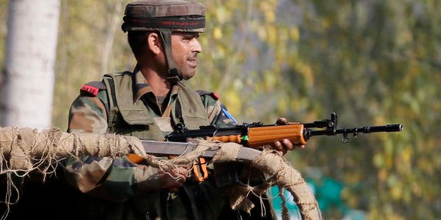 An Indian soldier guards outside the army base which was attacked Sunday by suspected militants at Uri, Indian controlled Kashmir, Monday, Sept. 19, 2016.
