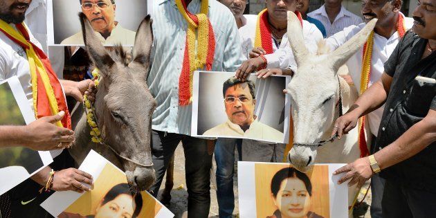 Activists of the Karnataka Rakshana Vedike hold posters of Karnataka Chief Minister, Siddaramaiah and Tamil Nadu Chief Minister, Jayalalithaa alongside donkeys during a protest in Bangalore on September 8, 2016, with regard to the Cauvery water dispute.