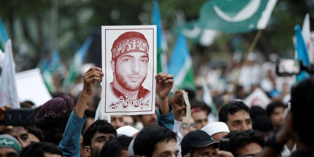 A picture of Hizbul Mujahideen commander Burhan Muzaffar Wani is held up during a rally condemning the violence in Kashmir, in Islamabad, Pakistan July 24, 2016. REUTERS/Caren Firouz