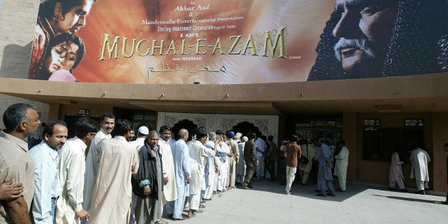People line up to buy tickets for the first screening in Pakistan of Indian classic movie Mughal-e-Azam at Gulistan at a cinema in Lahore April 23, 2006. The forbidden love of Pakistanis for Indian movies was allowed into the open on Sunday with the public screening of a 1960 classic beloved on both sides of the border. REUTERS/Mohsin Raza