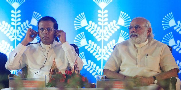 Prime Minister Narendra Modi looks on as Sri Lanka's President Maithripala Sirisena (L) adjusts his earphones during a seminar at the Simhastha Kumbh Mela in Ujjain, India, May 14, 2016.