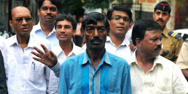Bhaiyalal Bhotmange (centre) arrives for a press conference in Mumbai on 28 July 2010. SAJJAD HUSSAIN/AFP/Getty Images