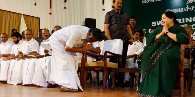 Former chief minister O. Panneerselvam bows in front of AIADMK leader Jayaram Jayalalitha after she took oath as the new Chief Minister of Tamil Nadu state in Chennai, India, Saturday, May 23, 2015.