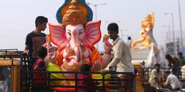 Devotees carry an idol of elephant-headed Hindu god Ganesha to worship it on occasion of Ganesh Chaturthi...