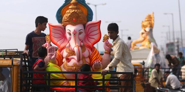 Devotees carry an idol of elephant-headed Hindu god Ganesha to worship it on occasion of Ganesh Chaturthi festival, in Hyderabad, India, Monday, Sept. 5, 2016. The idol will be immersed in water bodies after worship at the end of the festival. (AP Photo/Mahesh Kumar A.)