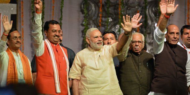 Indian Prime Minister Narendra Modi (C) takes part in Dussehra celebrations, next to Uttar Pradesh Governor Ram Naik (2nd R) in Lucknow on October 11, 2016.