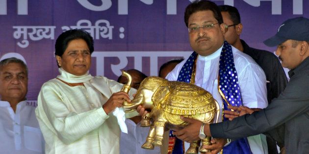 Mayawati (2nd L), chief of Bahujan Samaj Party (BSP), receives a model of an elephant, the BSP's electoral symbol, presented to her by her party's candidate Yogesh Divedi during an election campaign rally in the northern Indian city of Mathura April 18, 2014.
