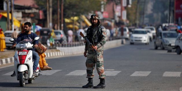 An Indian army soldier stands guard on a road on the outskirts of Srinagar, October 3, 2016.