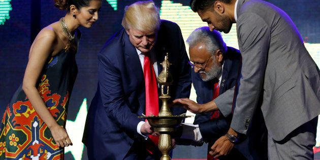 Republican Hindu Coalition Chairman Shalli Kumar (2nd R) helps Republican presidential nominee Donald Trump (2nd L) light a ceremonial diya lamp before he speaks at a Bollywood-themed charity concert put on by the Republican Hindu Coalition in Edison, New Jersey, U.S. October 15, 2016.