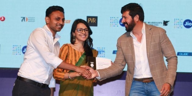 Filmmaker Kabir Khan hands out the Young Critics Choice award to Amit Madhesiya and Shirley Abraham for 'The Cinema Travellers.'