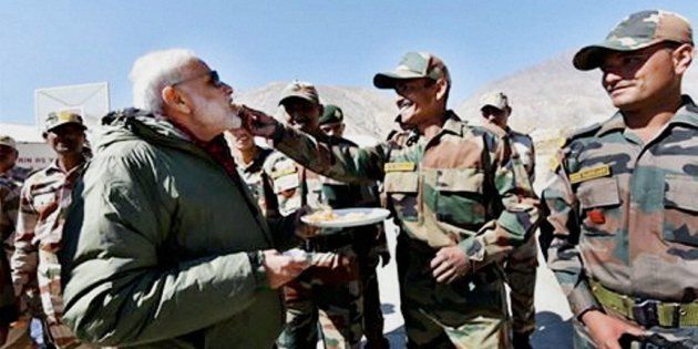 Sumdo: Jawans offer sweets to Prime Minister Narendra Modi on the occassion of Diwali, at Sumdo in Himachal Pradesh on Sunday. PTI Photo (PTI10_30_2016_000049B)