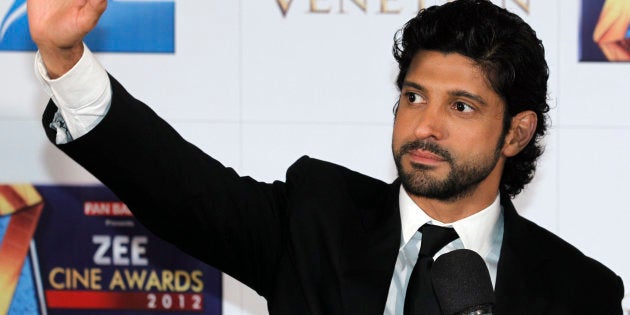 India's director-actor Farhan Akhtar waves on the red carpet of the Zee Cine Awards 2012 in Macau Saturday, Jan. 21, 2012. (AP Photo/Kin Cheung)