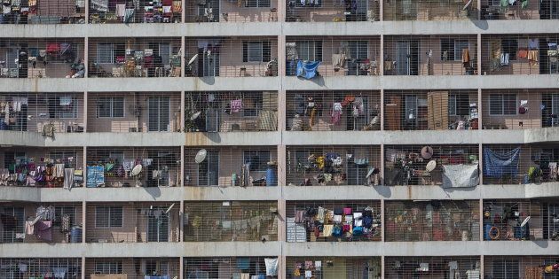 Windows of various apartments of a high-rise residential building are seen in the western suburb of Mumbai.