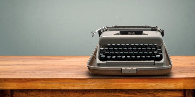 Old retro Typewriter on table with vintage gray gradient background