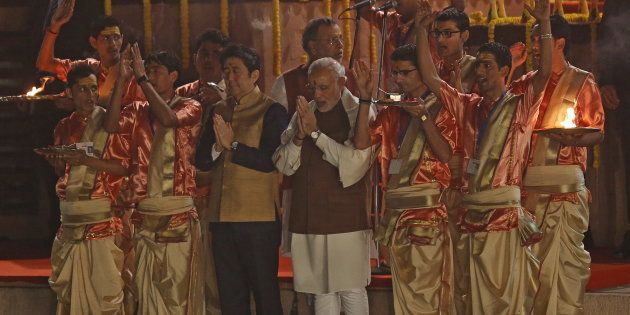 Japan's Prime Minister Shinzo Abe (front, 3rd L) and his Indian counterpart Narendra Modi perform a religious ritual during evening prayers on the banks of the river Ganges in Varanasi, India, December 12, 2015.