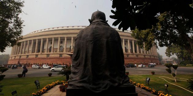A bird sits on a statue of Mahatma Gandhi outside the parliament building in New Delhi, India, Tuesday, Nov. 22, 2011. The winter session of the Indian parliament began Tuesday. (AP Photo/Manish Swarup)