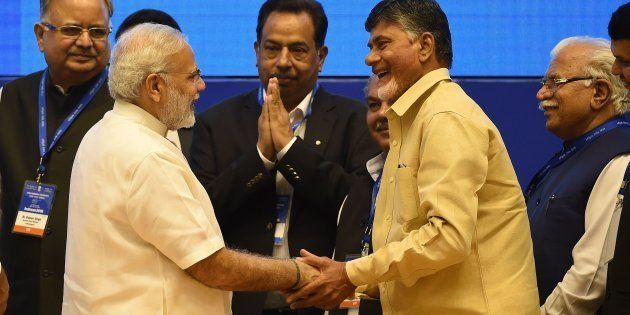 Prime Minister Narendra Modi (2L) shakes hands with Chief Minister of Andhra Pradesh state Chandrababu Naidu (2R) on 30 September 2016. PRAKASH SINGH/AFP/Getty Images