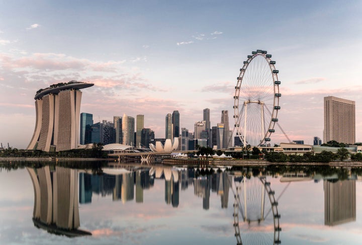 Singapore skyline at dawn, showing the Marina Bay Sands and the Flyer.