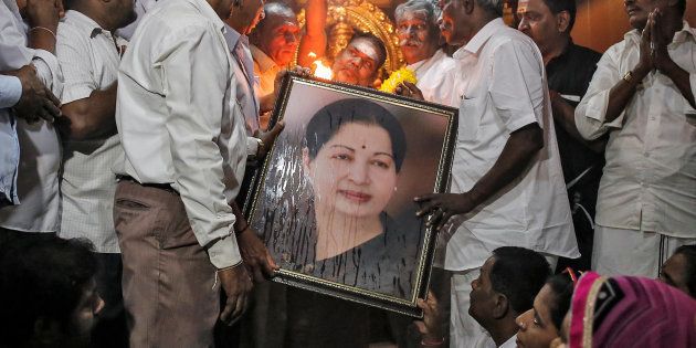 Well wishers of Tamil Nadu Chief Minister Jayalalithaa Jayaraman hold her portrait as they pray at a temple in Mumbai, India, December 5, 2016. REUTERS/Danish Siddiqui