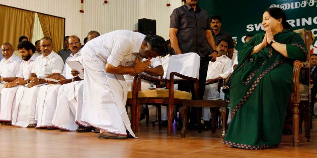 Former chief minister O. Panneerselvam bows in front of AIADMK leader Jayaram Jayalalitha after she took oath as the new Chief Minister of Tamil Nadu state on May 23, 2015.