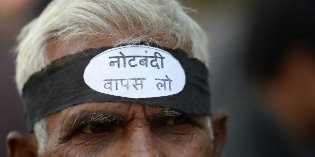 An activist from the Communist Party of India wearing a headband shouts slogans against the government of Prime Minister Narendra Modi during a protest against demonetisation in New Delhi on November 28, 2016.